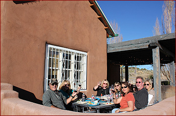 A New Mexico Wine Tours group enjoying a delicious meal and of course, wine!